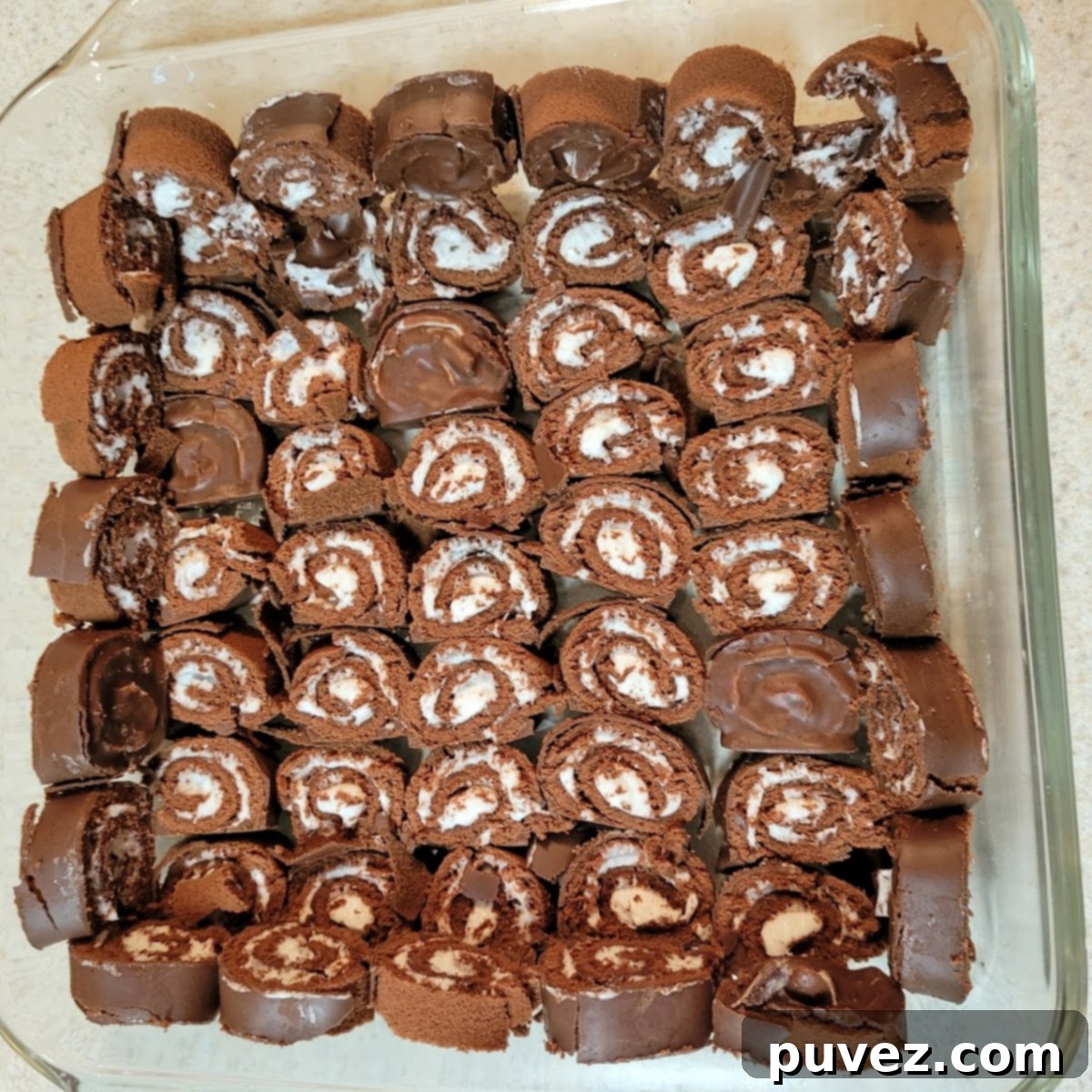 The decadent chocolate mousse mixture, smooth and airy, ready to be poured over the Swiss roll base