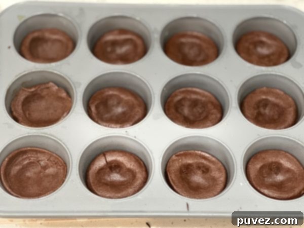 Grasshopper Pie Cookie Cups in the cupcake pan before baking, showing the carefully formed cookie cups ready for the oven.