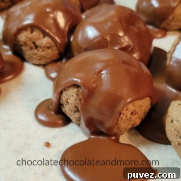 Close-up shot of several Italian Chocolate Pepper Cookies, freshly iced and glistening, showing their dark, rich color and smooth glaze.