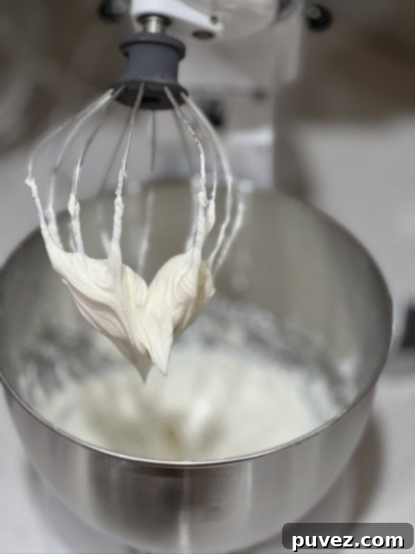 Creamy cheesecake filling in a mixing bowl, ready to be layered into the casserole