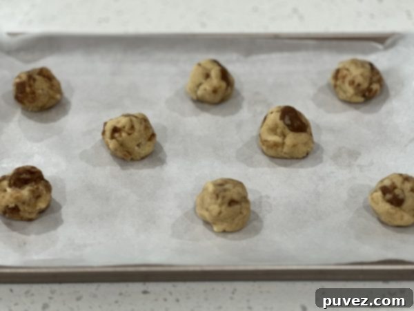 A batch of delicious Cinnamon Roll Sugar Cookies on a cooling rack.