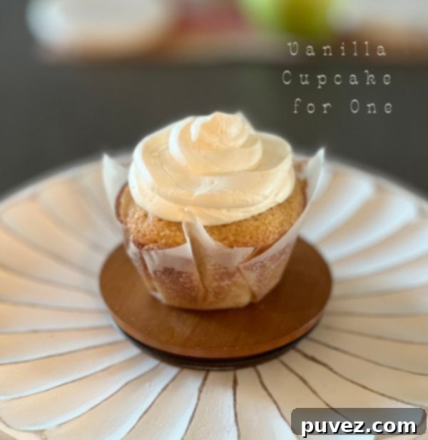 A beautifully frosted jumbo vanilla cupcake for one, ready to be enjoyed.