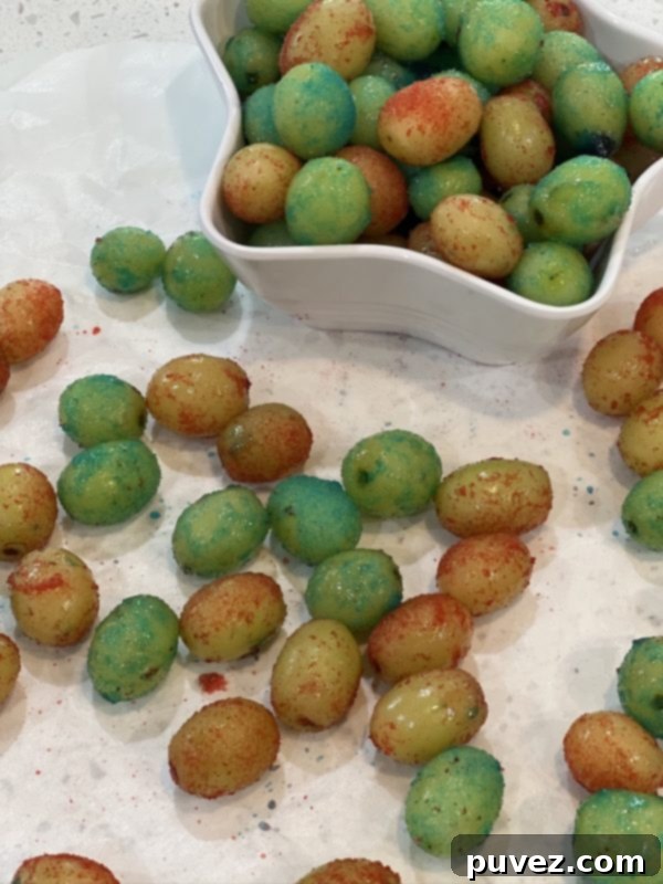 Close-up of Frozen Jello Grapes in a bowl, showcasing their vibrant colors
