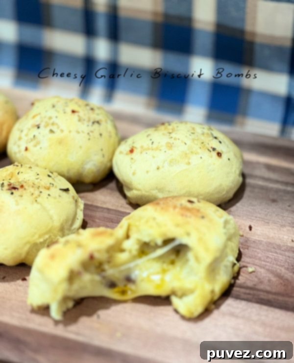 Delicious Cheesy Garlic Biscuit Bombs on a baking sheet, golden brown and ready to eat.