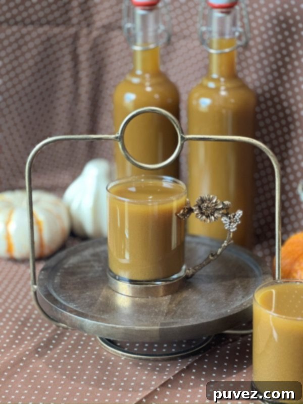 Homemade Pumpkin Apple Cider gently simmering in a large pot on a stovetop, with steam rising, showcasing the rich color.