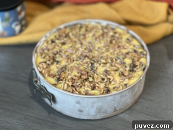 No-Bake German Chocolate Cheesecake mid-process, with filling and ganache layers applied