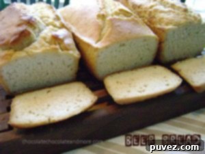 Freshly baked golden brown beer bread loaf on a cooling rack
