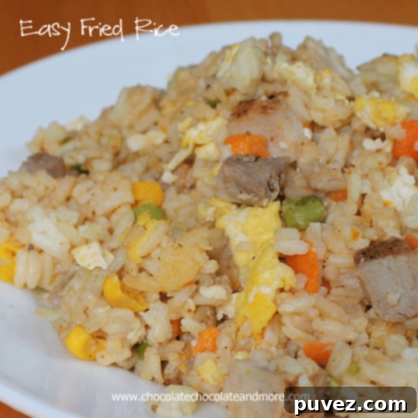 A bowl of freshly made Easy Fried Rice, garnished with fresh herbs