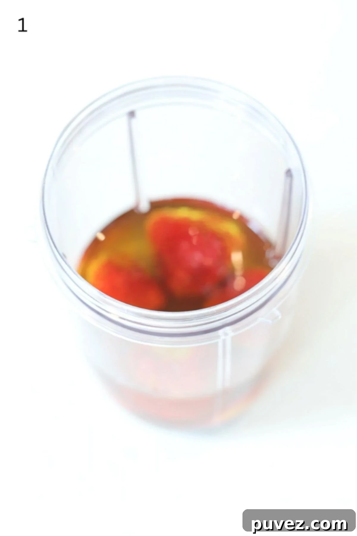 Strawberry salad dressing ingredients in a Nutri bullet blender container.