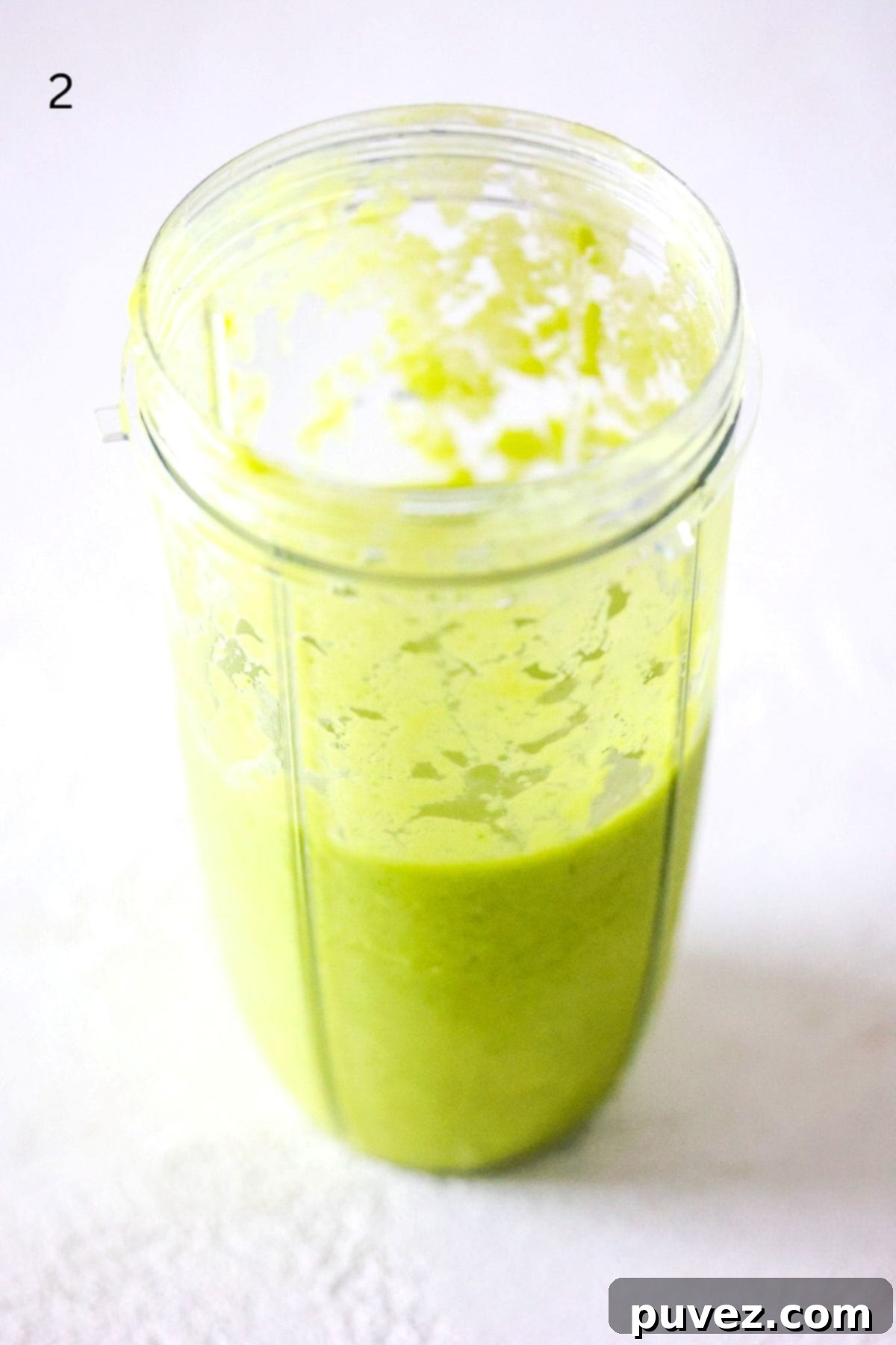 Island Green Paradise Smoothie 5 The blended tropical green smoothie inside a NutriBullet Pro blender cup, showing its smooth and creamy consistency, ready to be poured.