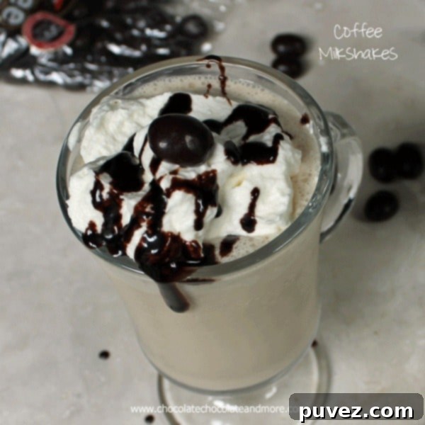 Coffee Milkshake with a generous topping of whipped cream and chocolate covered coffee beans