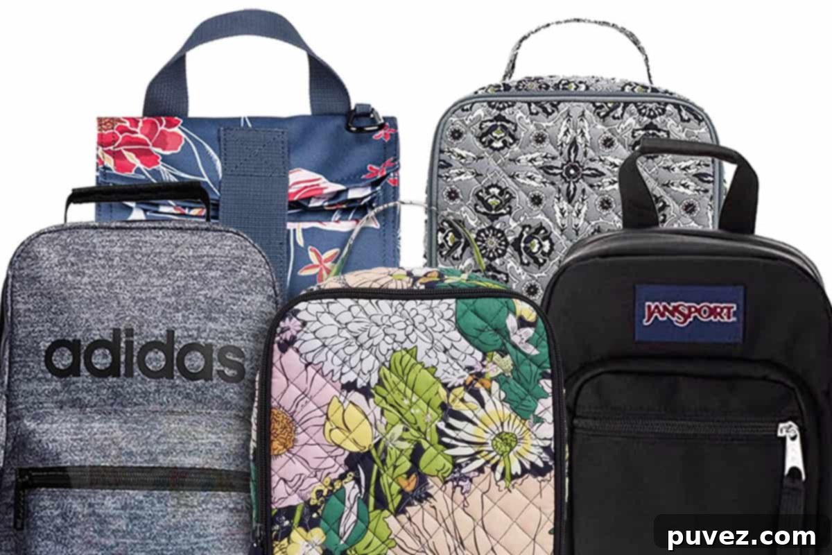 Five stylish lunch boxes displayed. From left to right: Adidas (grey and black), Vera Bradley (floral pattern), Jansport backpack style (black). Back row: Roxy (blue floral pattern) and Vera Bradley (grey and black detail).