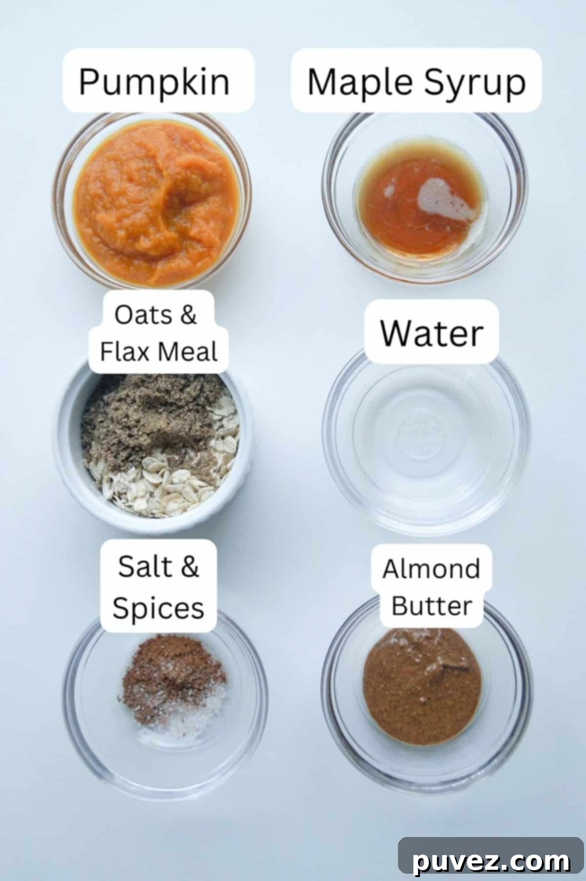 Two vertical rows of small glass prep bowls, labeled: one with pumpkin puree, one with maple syrup, one with oats and flax meal, one with water, one with salt and spices, and one with almond butter.