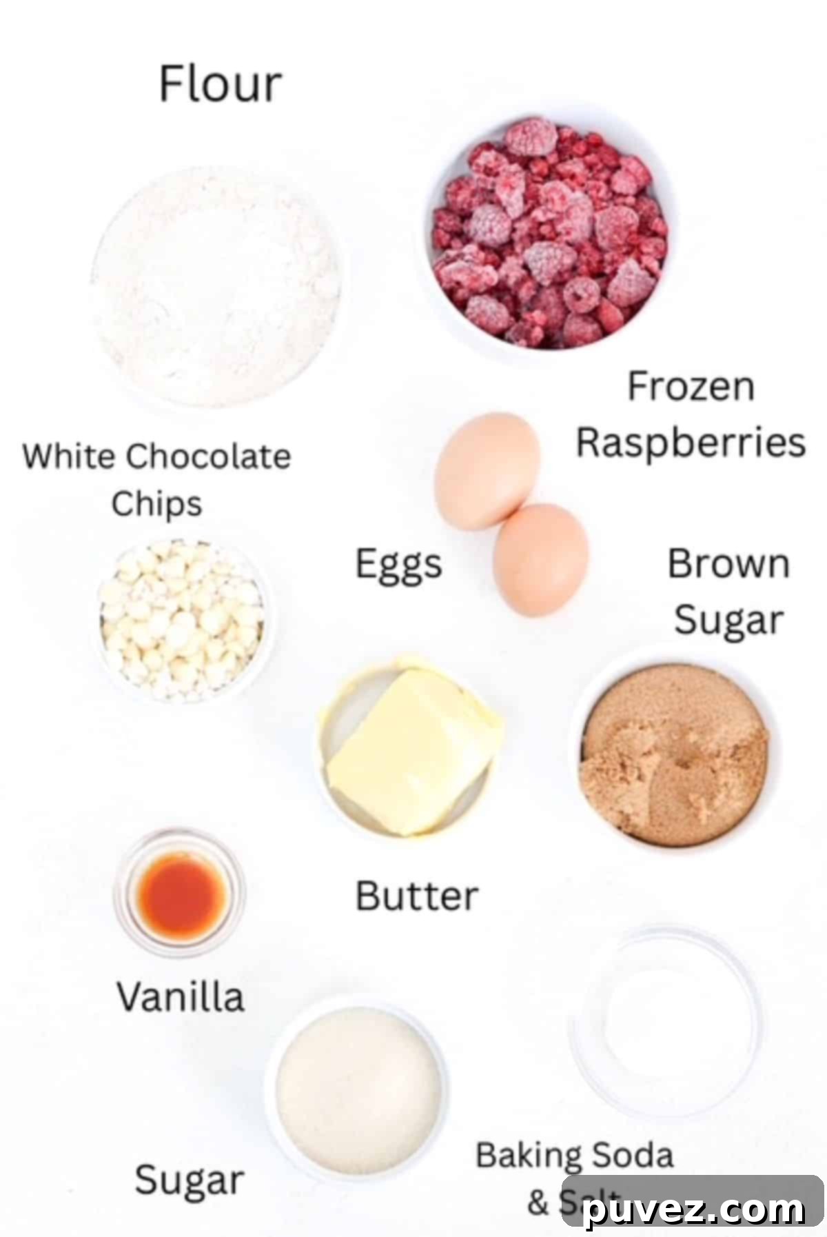 A collection of ingredients for Raspberry and White Chocolate Blondies, neatly arranged and labeled on a white surface.