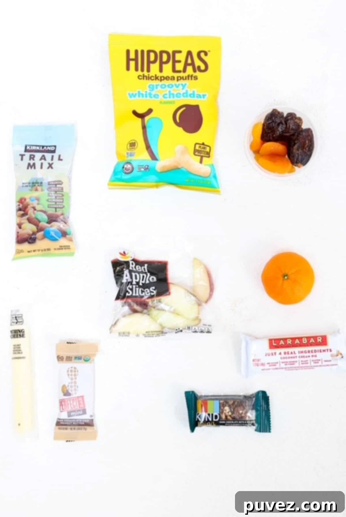 Ten different healthy travel snacks arranged neatly on a white background.