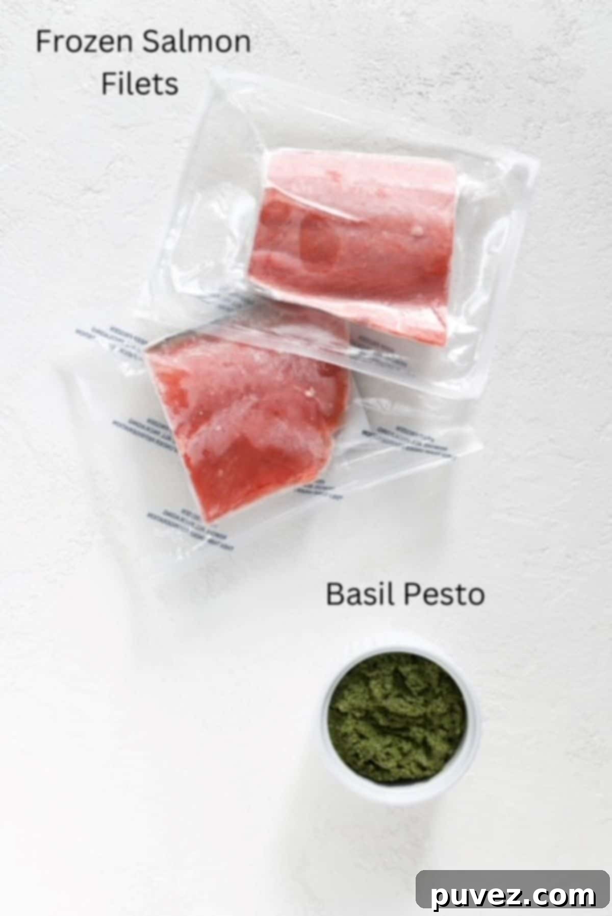 Two pieces of frozen salmon vacuum sealed and pesto in a white serving dish, labeled.
