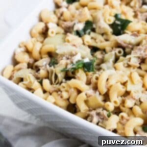 Delicious Tuna Pasta meal with Feta and Artichokes in a square white 9x9 serving dish.