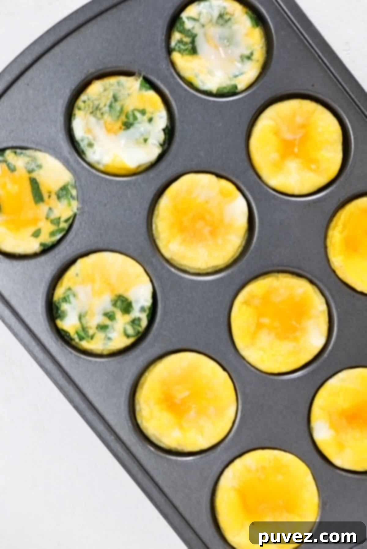 Baked eggs in a muffin tin, some plain and some with spinach and cheese.