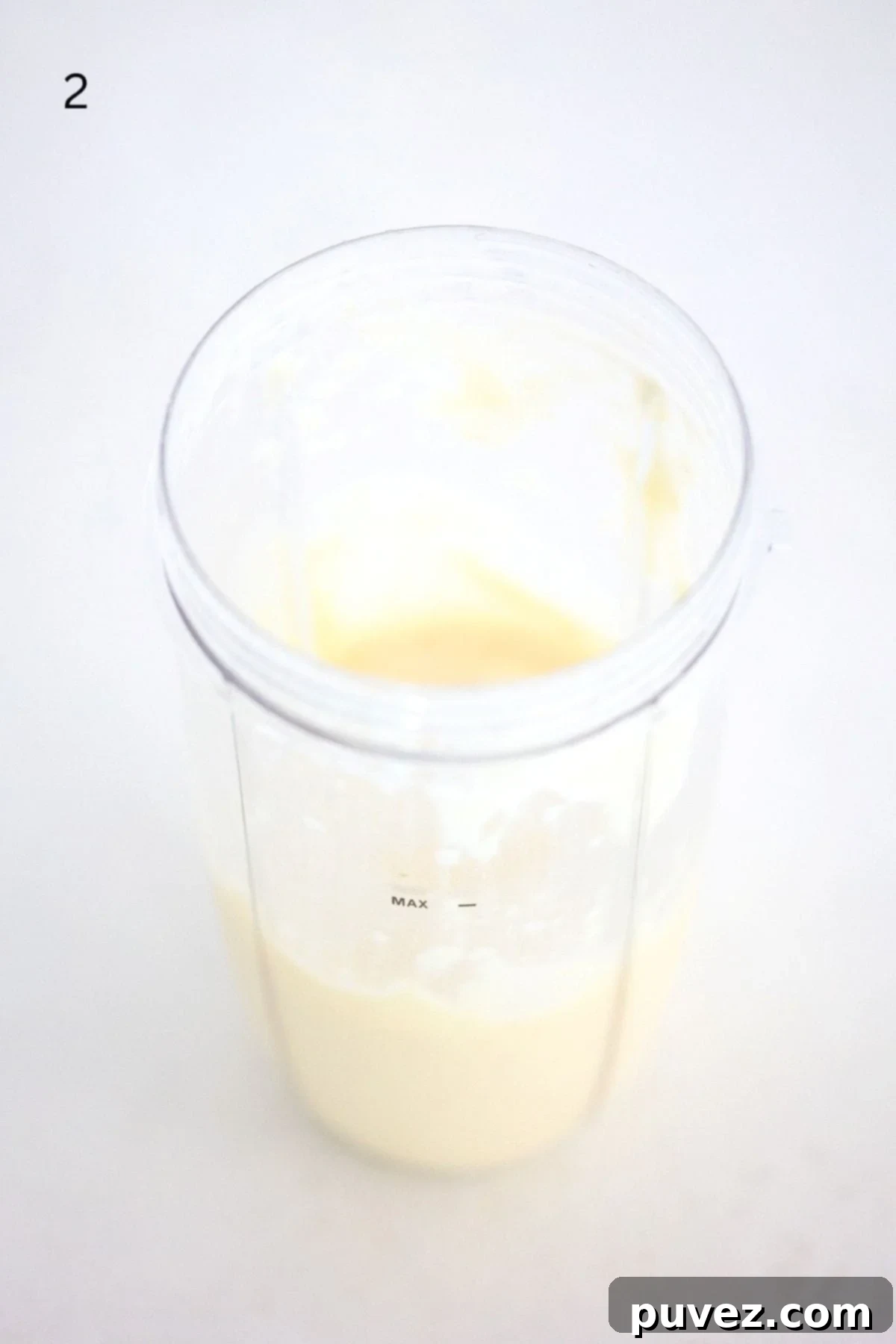 A blended Mango Pineapple Smoothie mixture in a NutriBullet Pro blender cup, showing a smooth, creamy texture, ready to be served.