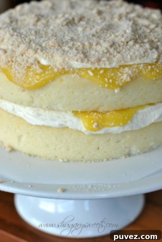 Lemon Cake with Creamy Filling and Lemon Curd, a tender cake with luscious cream and bright lemon curd.
