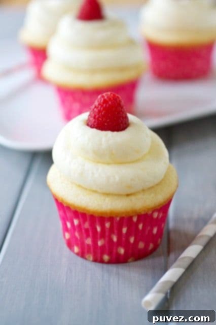 Lemon Cupcakes with Fresh Raspberry Curd Filling, elegant and bursting with sweet and tart flavors.