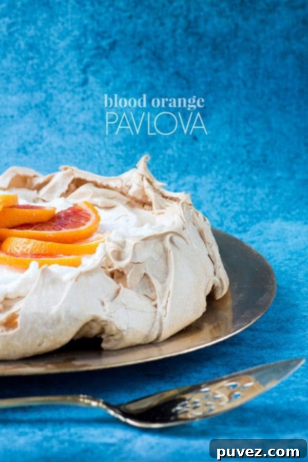 Blood Orange Pavlova with a crisp meringue and vibrant, juicy blood orange segments.