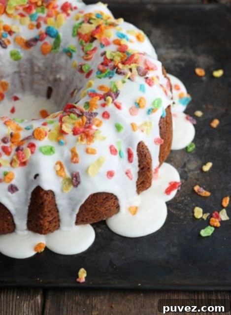 Strawberry Fruity Pebble Bundt Cake - A colorful and fun Bundt cake with strawberry flavor and a crunchy Fruity Pebble topping.