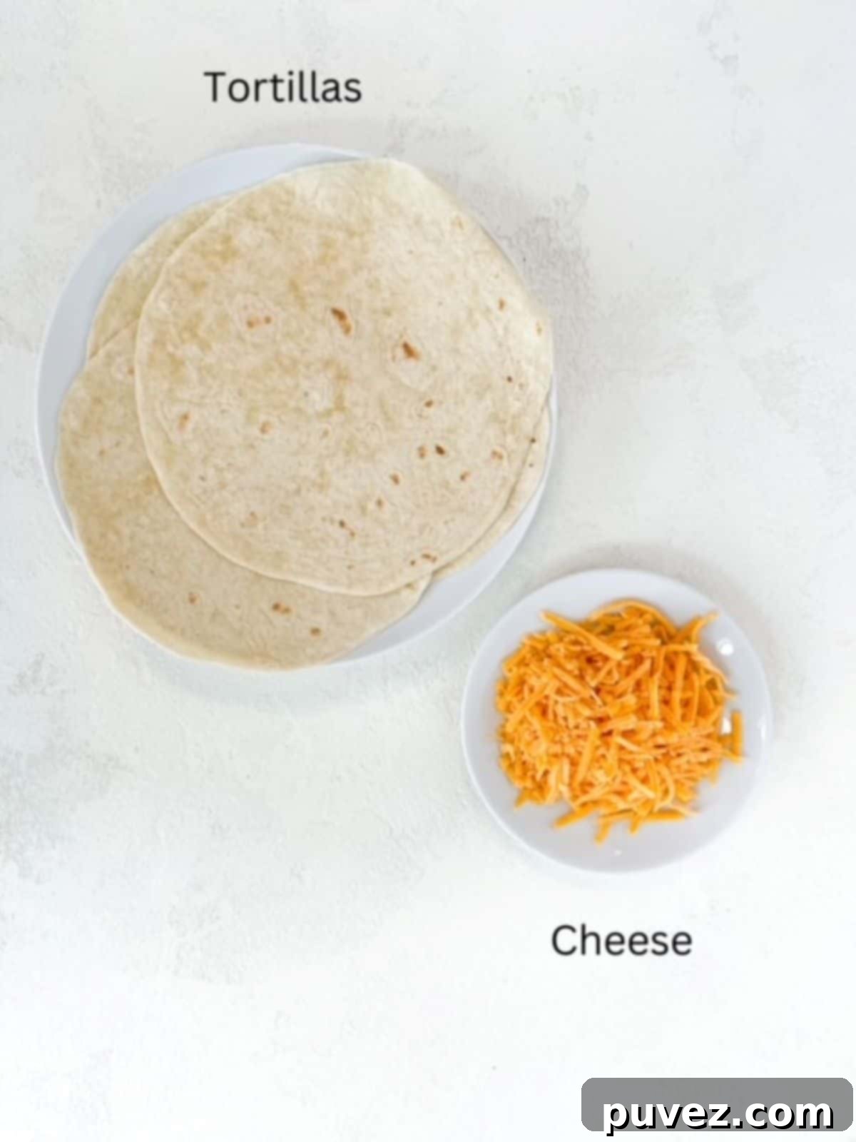 Flour tortillas and shredded cheddar cheese plated separately and labeled.