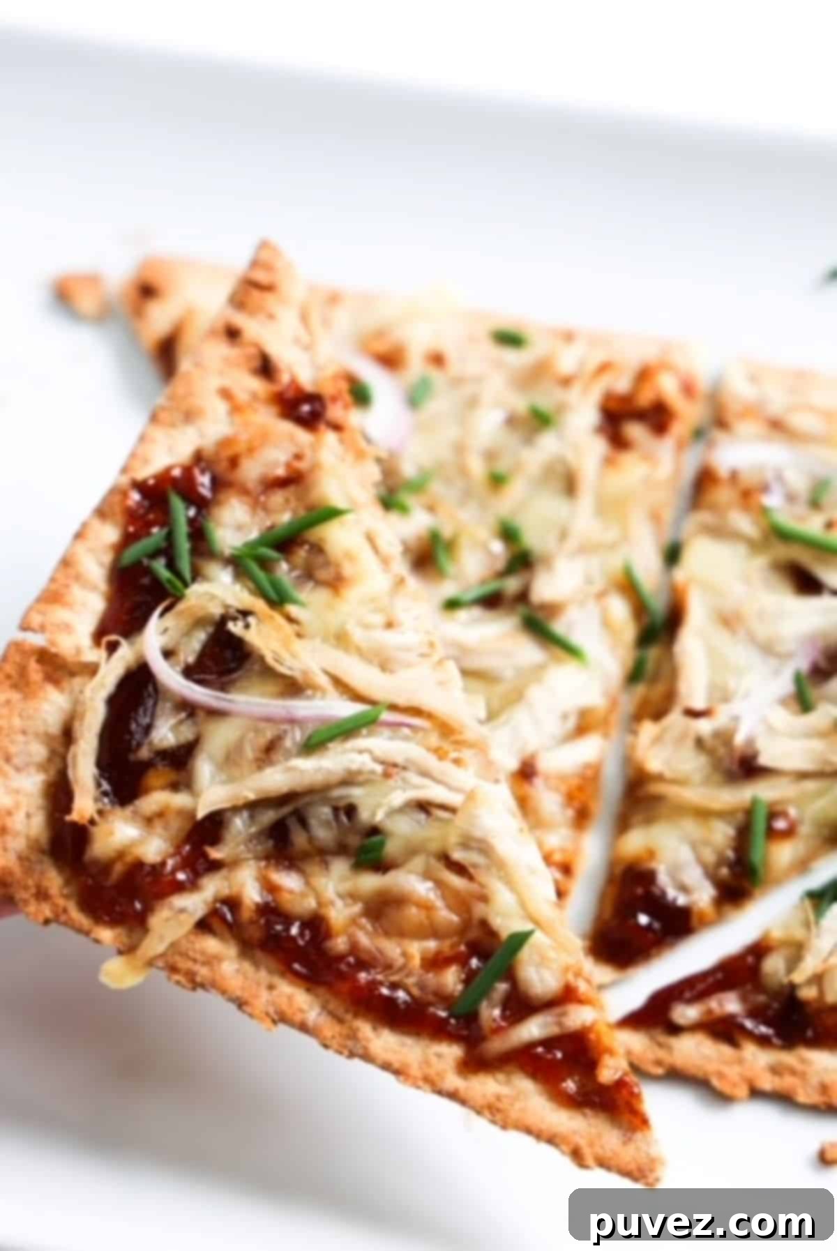 Blazing BBQ Chicken Flatbread in Minutes 5 BBQ chicken flatbread with one slice being held up close.