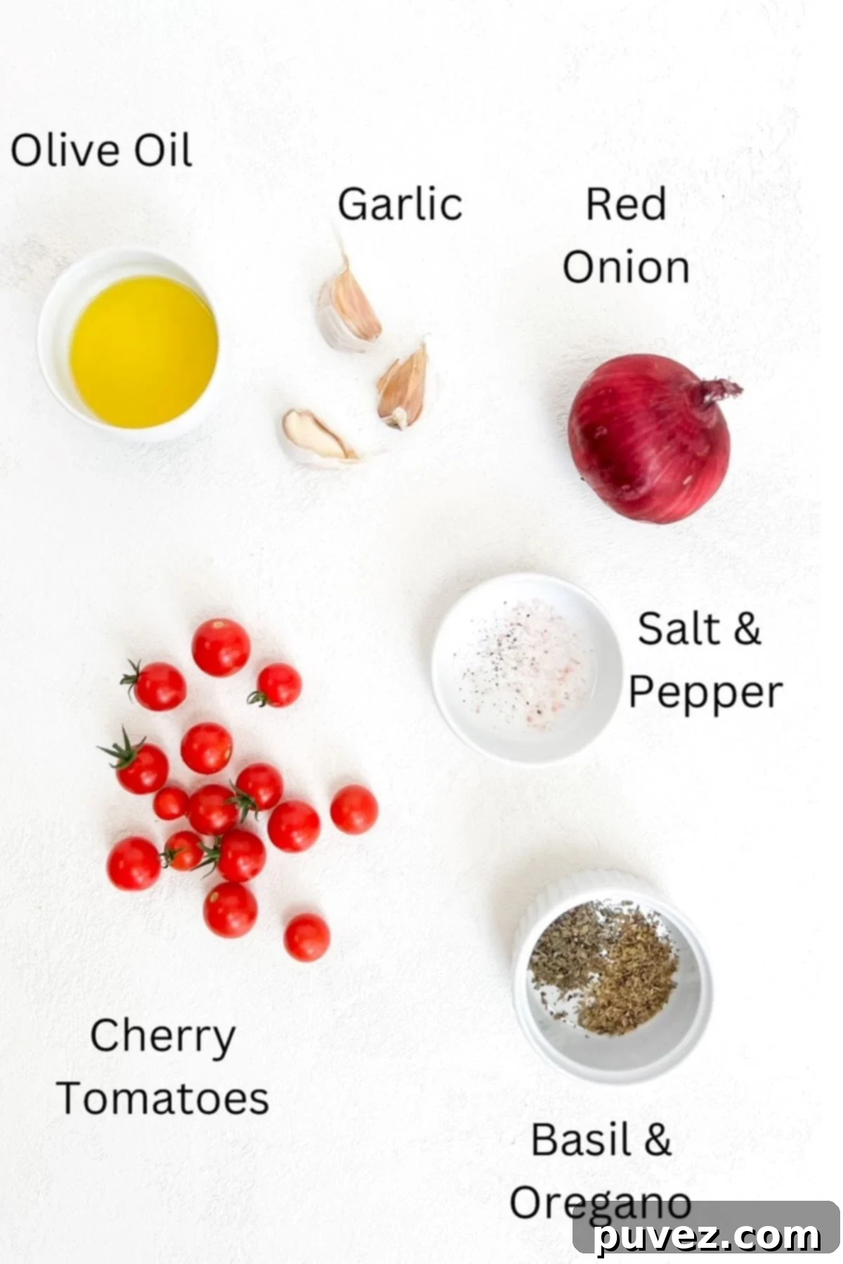 Olive oil, three garlic cloves, one red onion, cherry tomatoes, salt and pepper, basil and oregano placed separately on a white background and labeled.