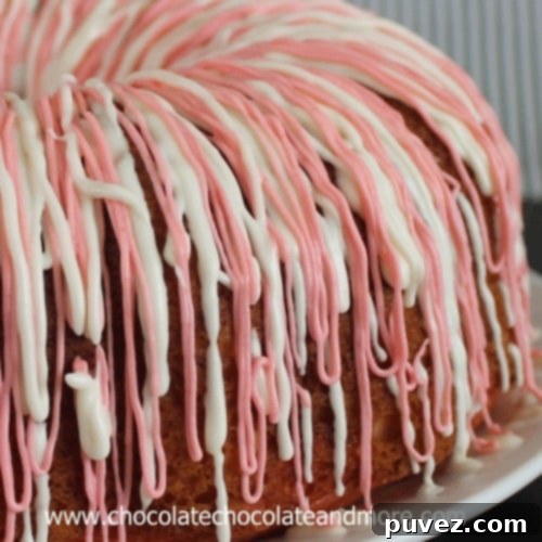 A slice of Strawberries and Cream Bundt Cake showing its pink and white layers