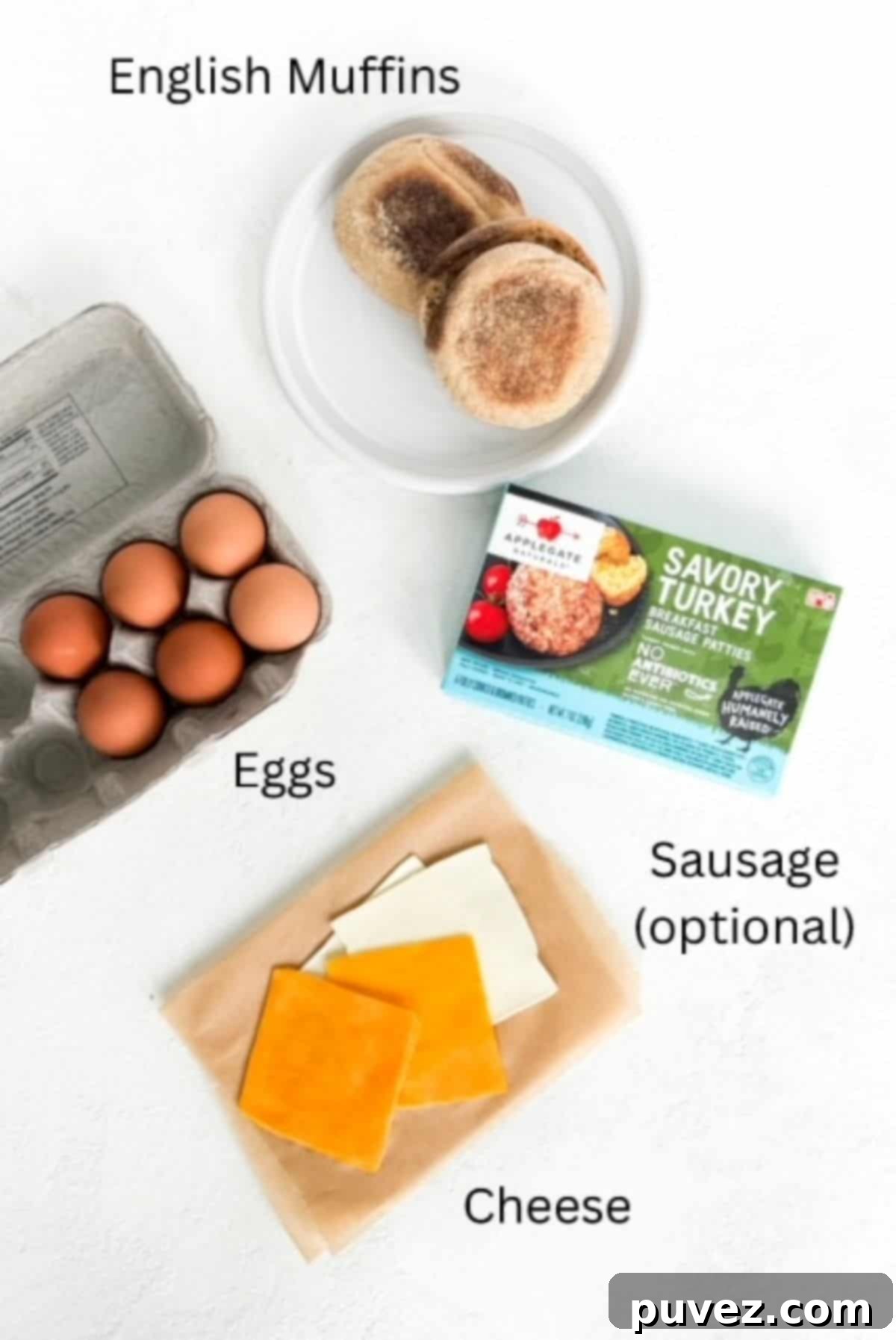 Ingredients for making a sausage, egg, and cheese breakfast sandwich on an English muffin, labeled.