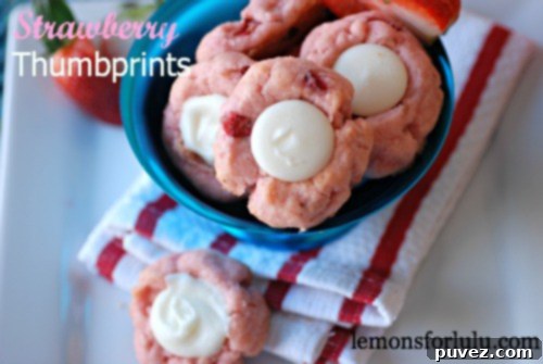 Strawberry Thumbprint Cookies with sweet pastel red strawberry jam centers.