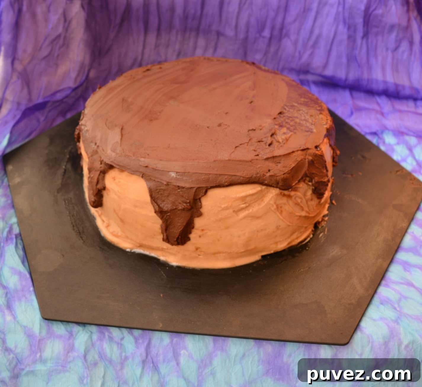 Whole Golden Yellow Cake with caramel and chocolate on a serving board
