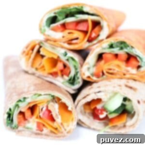 Five halves of hummus veggie wraps stacked together.