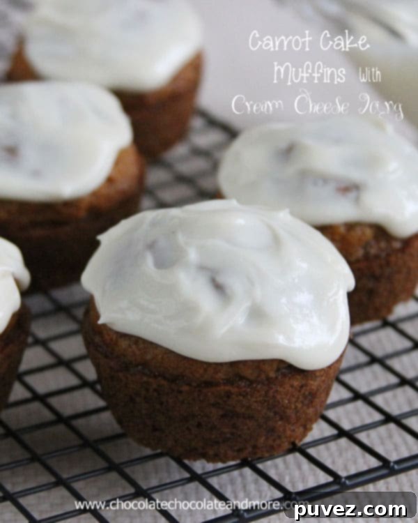 Decadent Carrot Cake Muffins generously topped with smooth cream cheese icing.