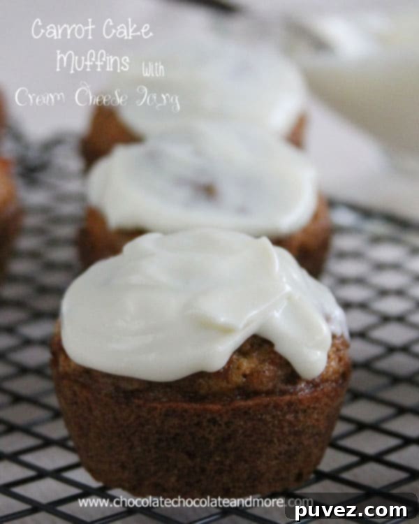 A beautifully arranged plate of frosted Carrot Cake Muffins, inviting and delicious.