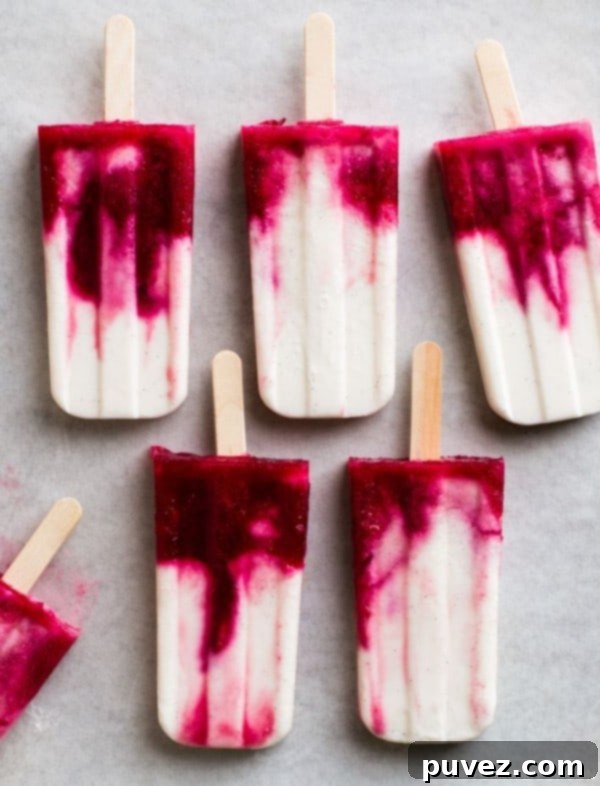 Vibrant Creamy Coconut and Blood Orange Popsicles, a sophisticated and refreshing frozen dessert.