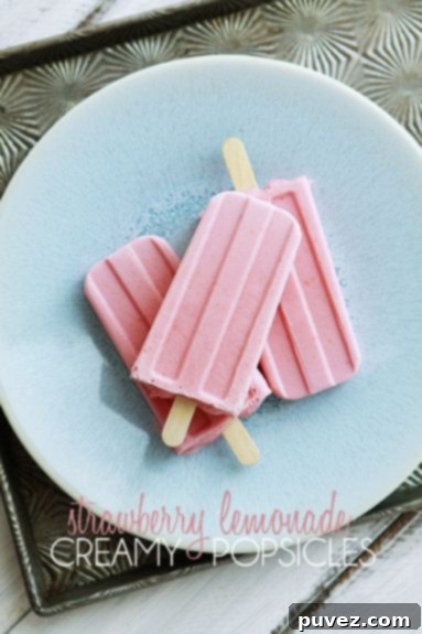 Creamy Strawberry Lemonade Popsicles, a perfectly balanced sweet, tangy, and refreshing frozen delight.