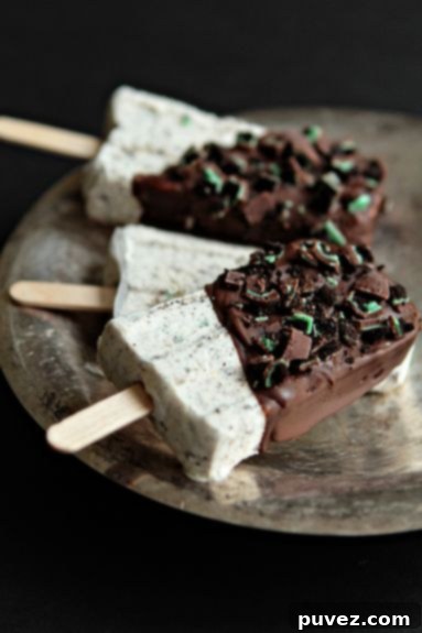 Sophisticated Mint Chocolate Cheesecake Popsicles, a creamy and refreshing frozen dessert with a cool minty twist.