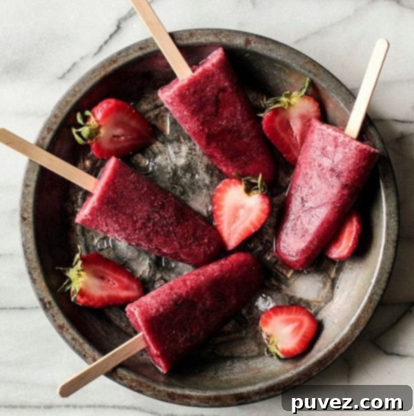 Sophisticated Roasted Strawberry Red Wine Popsicles, an exquisite frozen dessert for adult palates.