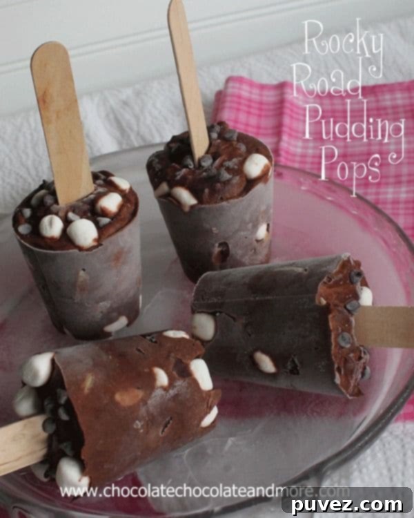 Fun Rocky Road Pudding Popsicles, a textured frozen dessert with chocolate, marshmallows, and nuts.