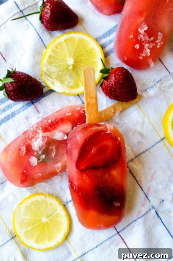Refreshing Strawberry Lemonade Popsicles, a sweet and tangy frozen treat perfect for summer.