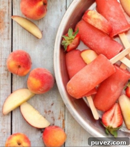 Adult Strawberry Peach Vodka Collins Popsicles, a refreshing boozy frozen cocktail for summer.