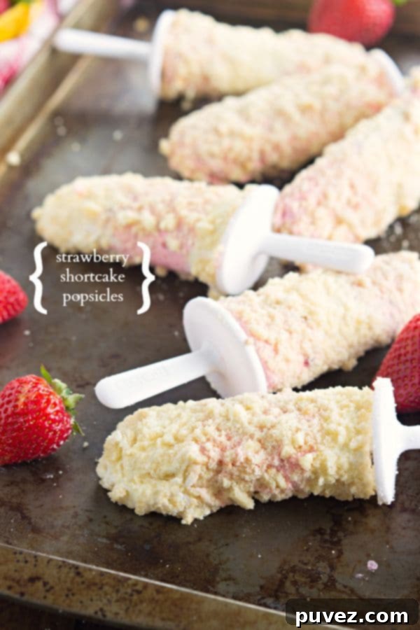 Delicious Strawberry Shortcake Popsicles, capturing the classic dessert's flavors in a frozen bar.