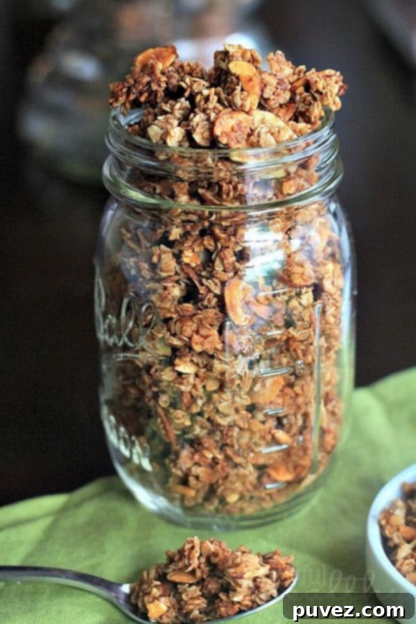 Homemade Almond Vanilla Granola in a bowl with a spoon.