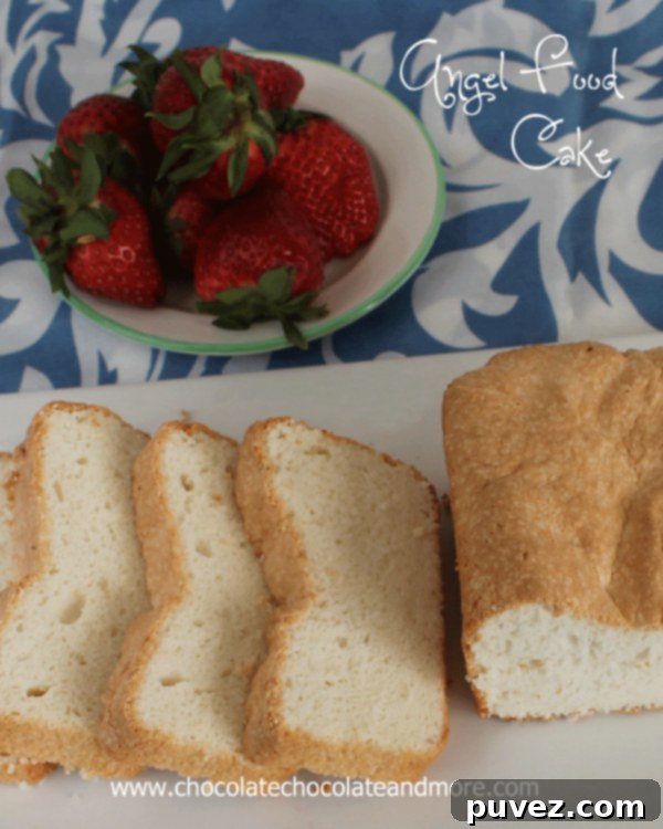 A slice of elegant Vanilla Angel Food Cake on a white plate.