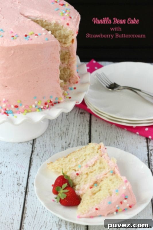 A multi-layered Vanilla Bean Cake with pink Strawberry Buttercream.