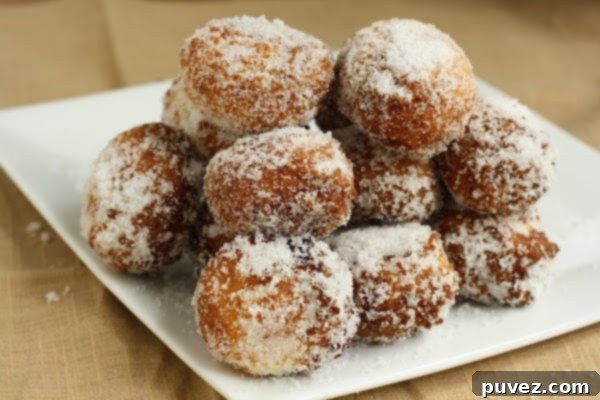 Pillowy 15 Minute Vanilla Bean Doughnut Holes dusted with powdered sugar.