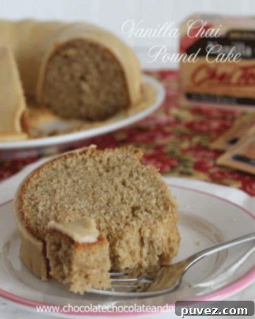 A slice of Vanilla Chai Pound Cake dusted with powdered sugar.